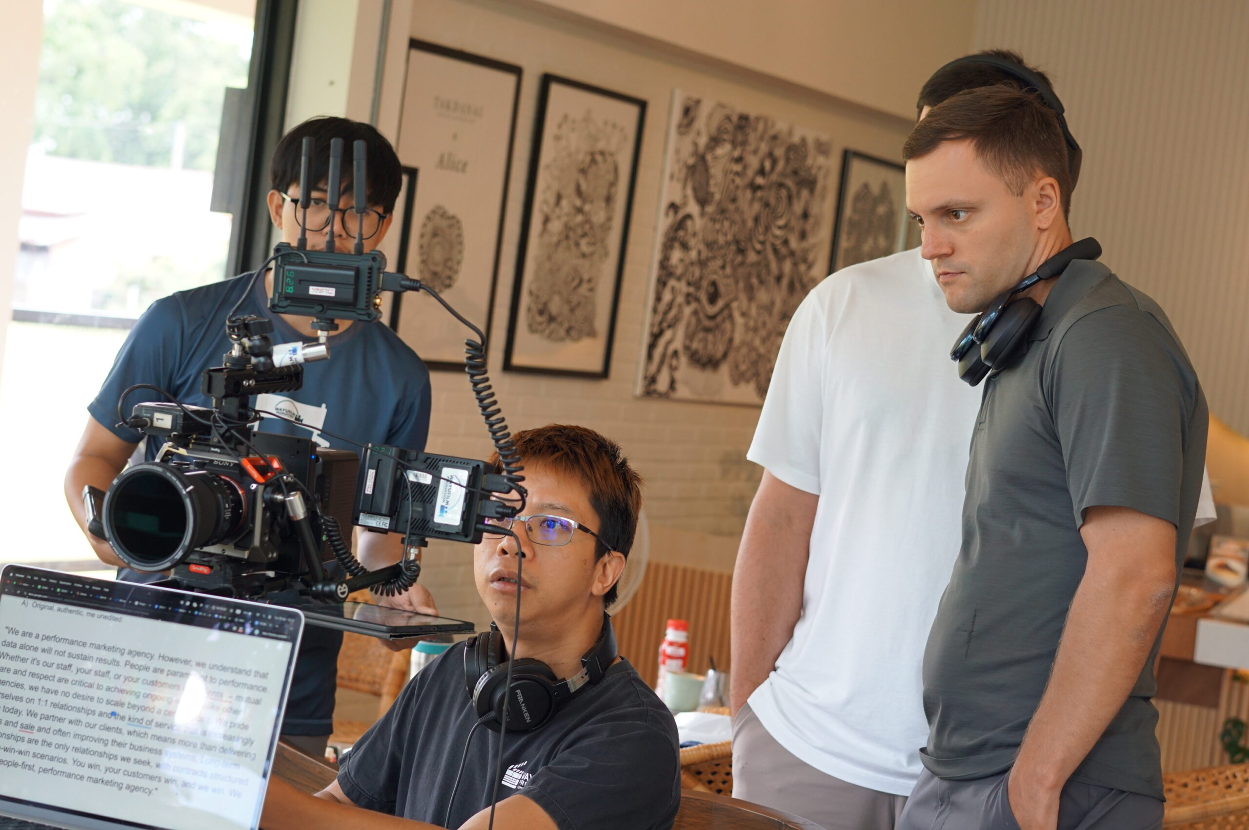 Video crew filming with a cinema camera on set